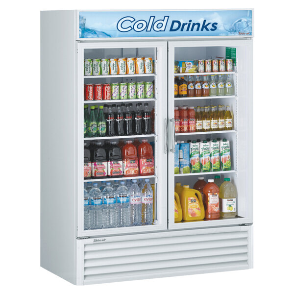 A Turbo Air white refrigerated merchandiser with drinks and beverages behind two glass doors.