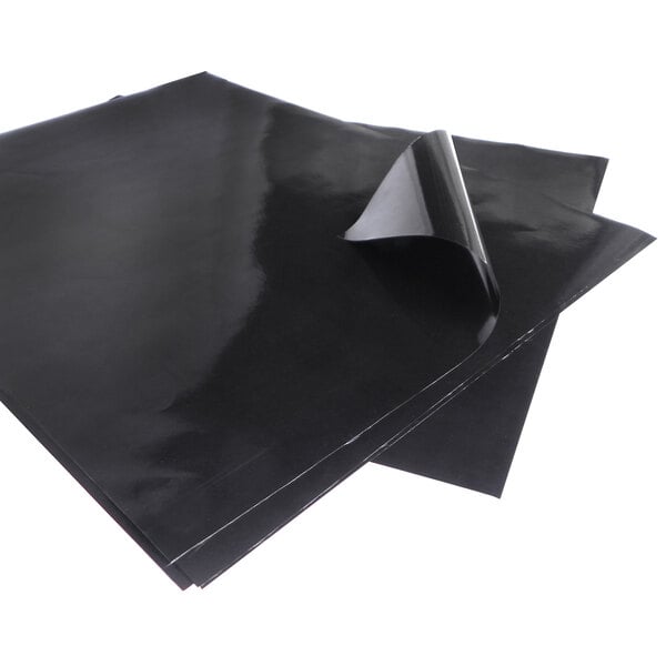 A black plastic wrapper on a white background with a black sheet inside.