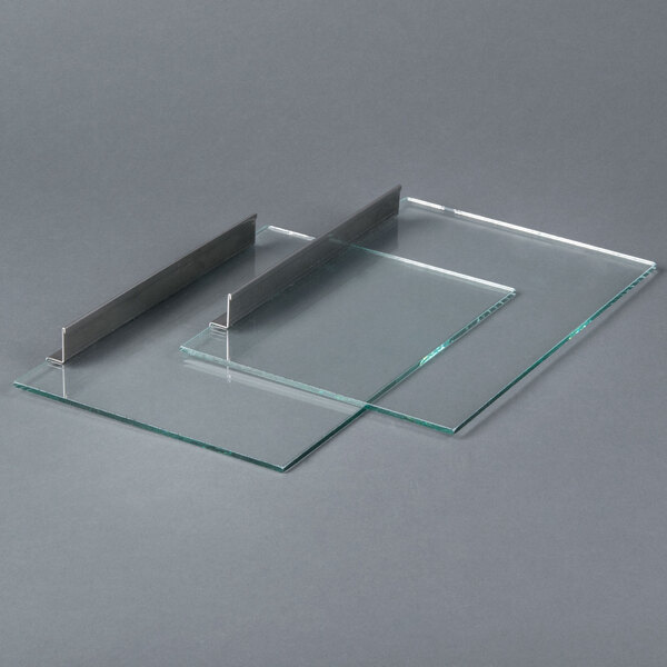 A pair of glass panels with metal corners.