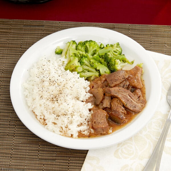 A Tuxton Colorado white narrow rim china plate with rice, meat and broccoli.