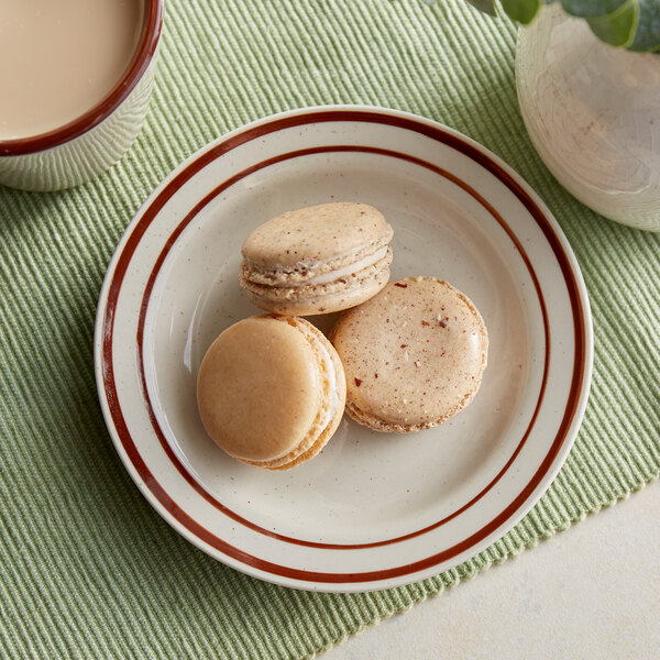 An Acopa brown speckle stoneware plate holding cookies and a cup of coffee.