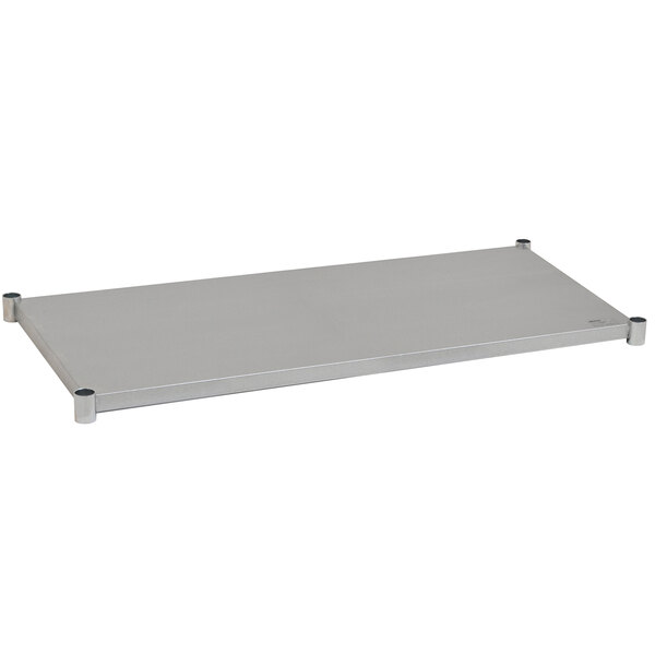 A metal shelf with metal legs designed to fit under a white rectangular Eagle Group work table.