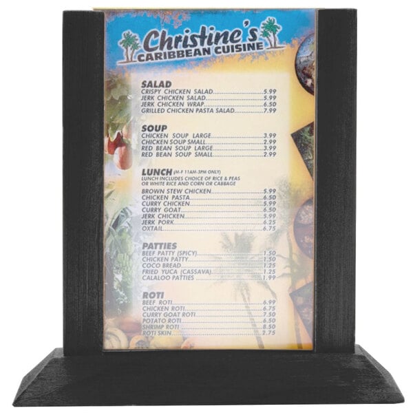 A Menu Solutions black wood table tent on a table with a menu inside.
