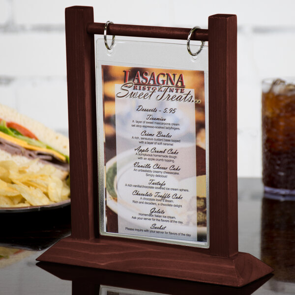 A mahogany wood flip top table tent with a menu on a table.