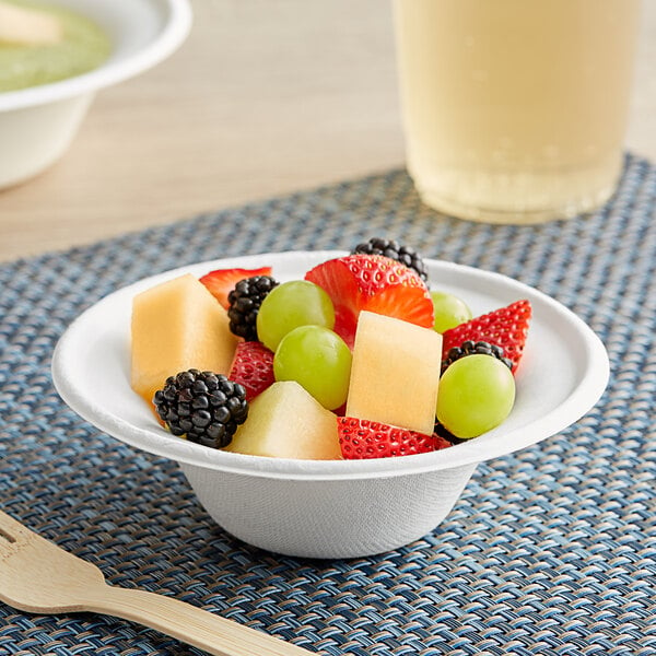 A bowl of fruit in an EcoChoice Bagasse bowl on a table.