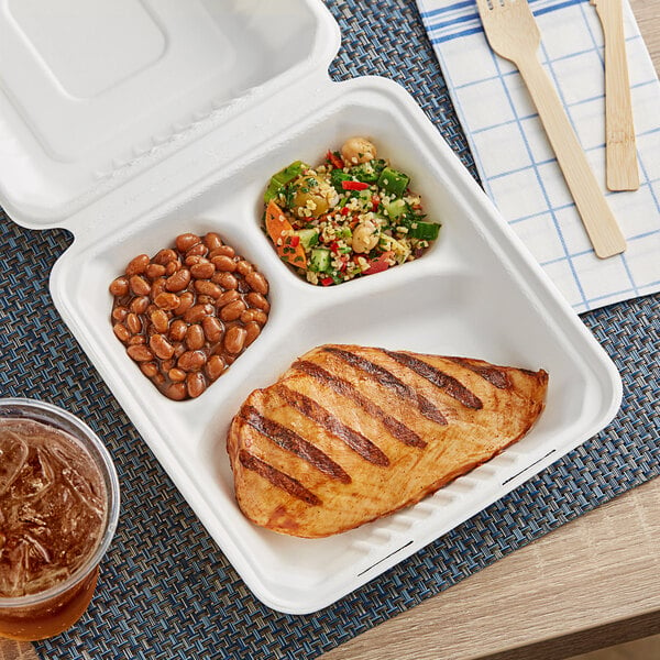 A white EcoChoice takeout box with 3 compartments holding grilled chicken, beans, and a drink.
