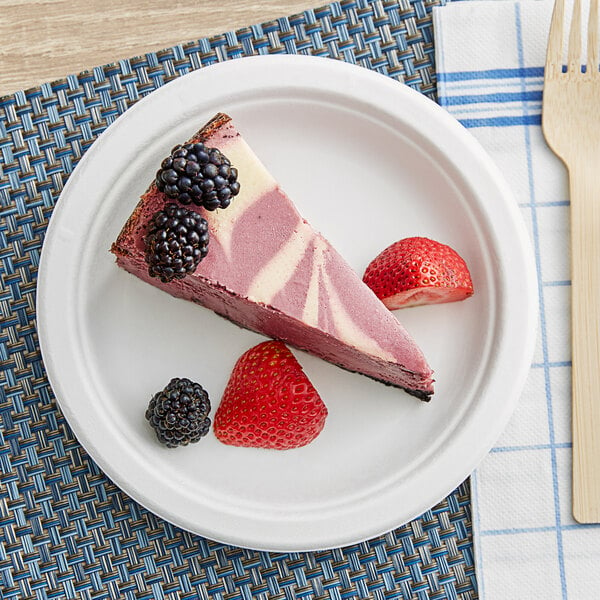 A slice of cheesecake with berries on an EcoChoice compostable sugarcane plate.