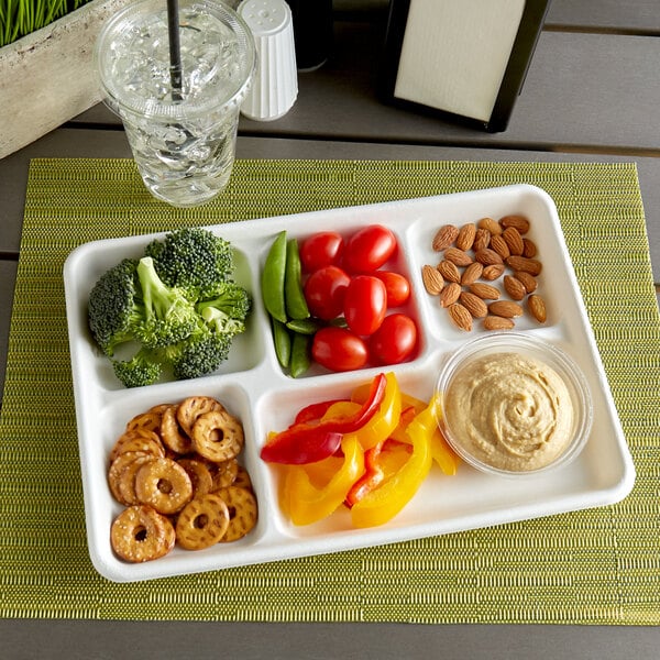 A white EcoChoice compostable bagasse tray with compartments filled with a variety of foods including broccoli.