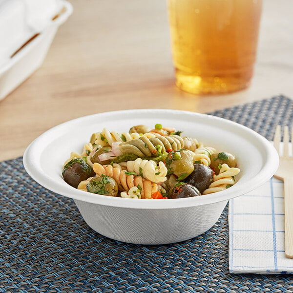 A EcoChoice Compostable sugarcane bowl filled with pasta, olives, and peppers.