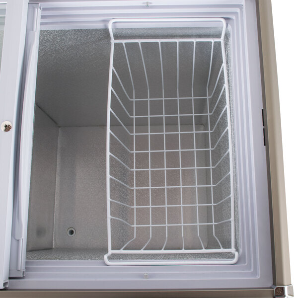 An Avantco white wire mesh hanging basket inside a white refrigerator.