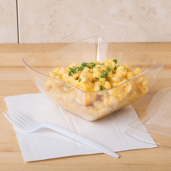 A clear plastic Fineline Wavetrends bowl filled with macaroni and cheese.