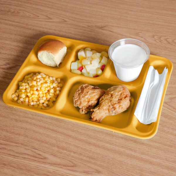 A yellow Cambro compartment tray with food on it.
