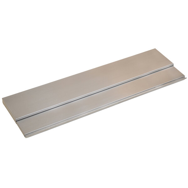 A silver metal cover with two long strips for an Eagle Group IC3-24 ice chest on a counter.