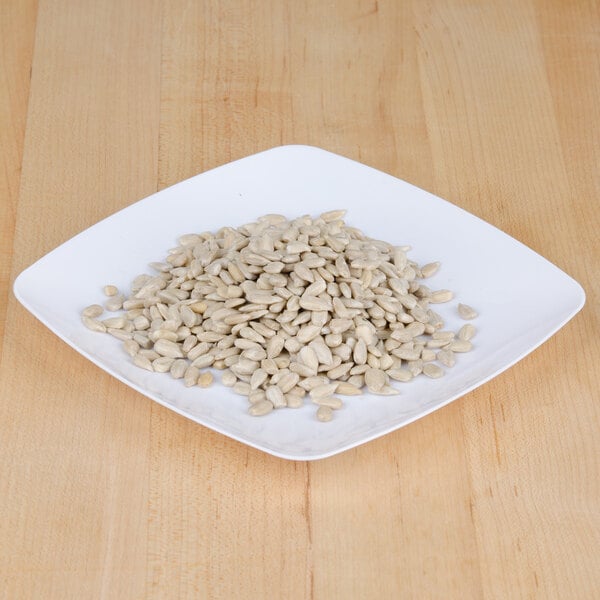 A white plate with a pile of Regal Raw Sunflower Seeds.