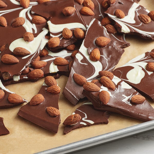 A plate of chocolate with whole almonds.