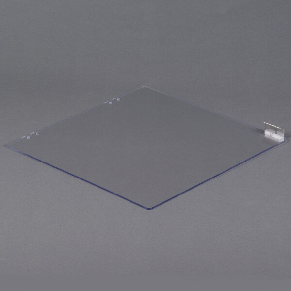 A clear plastic plate with a metal clip.