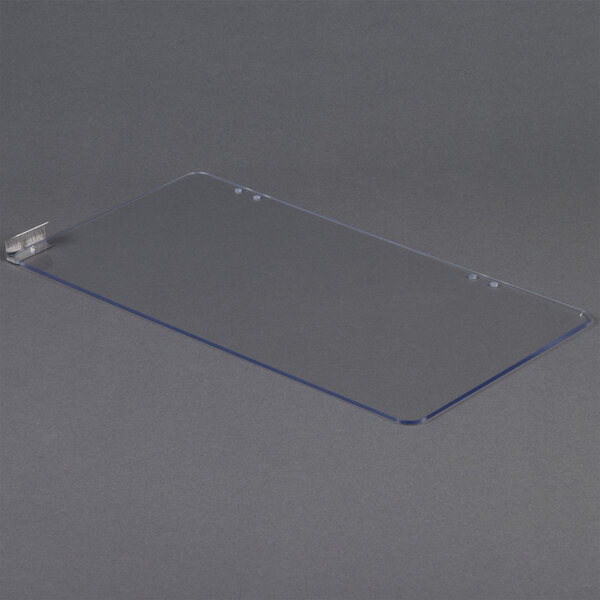 A clear plastic sheet with a metal bracket.