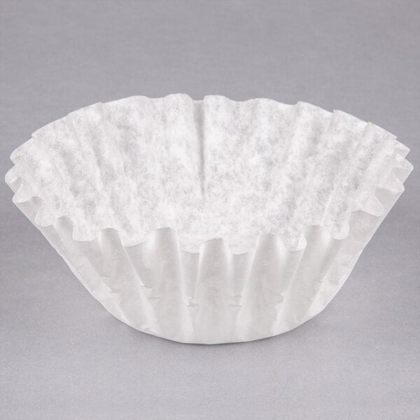 A Bunn paper coffee filter on a gray surface.