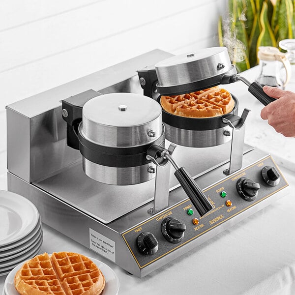 A person using a Carnival King double Belgian waffle maker to make waffles.