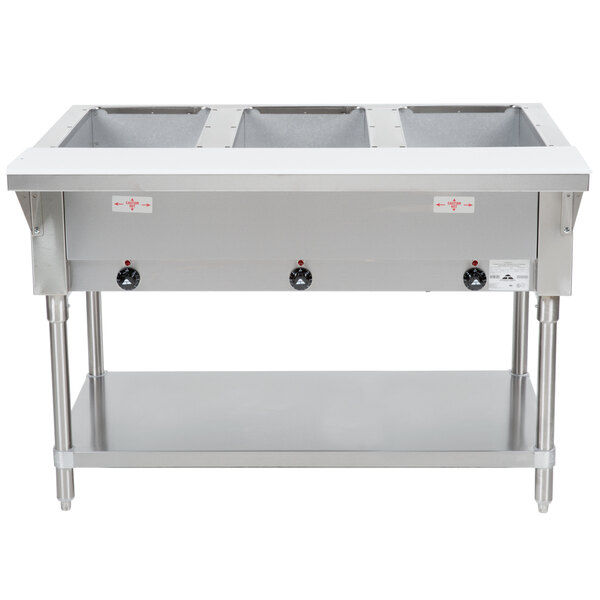 A stainless steel Advance Tabco electric steam table with an undershelf holding three open wells.