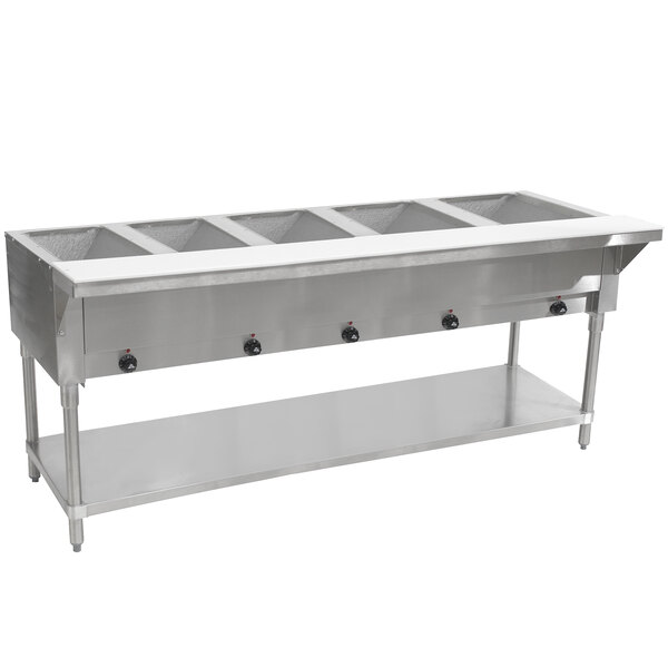 A stainless steel Advance Tabco hot food table with an undershelf holding food containers.