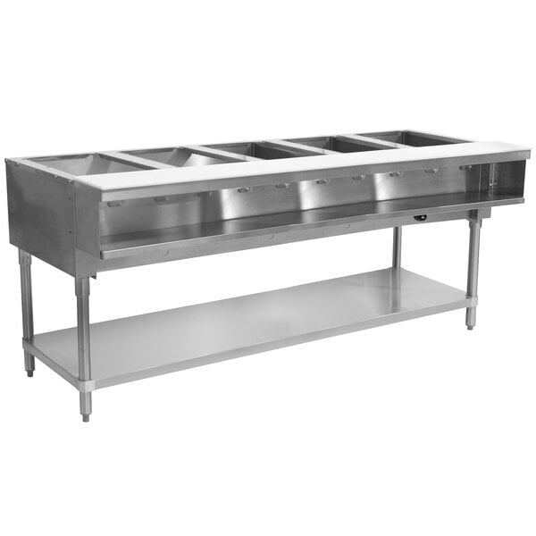 An Advance Tabco stainless steel hot food table with an undershelf holding five pans of food.