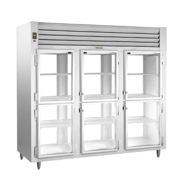 A white Traulsen narrow pass-through refrigerator with glass doors on two shelves.