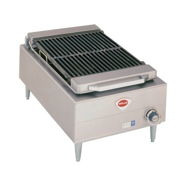 A stainless steel Wells Charbroiler grill top on a counter.