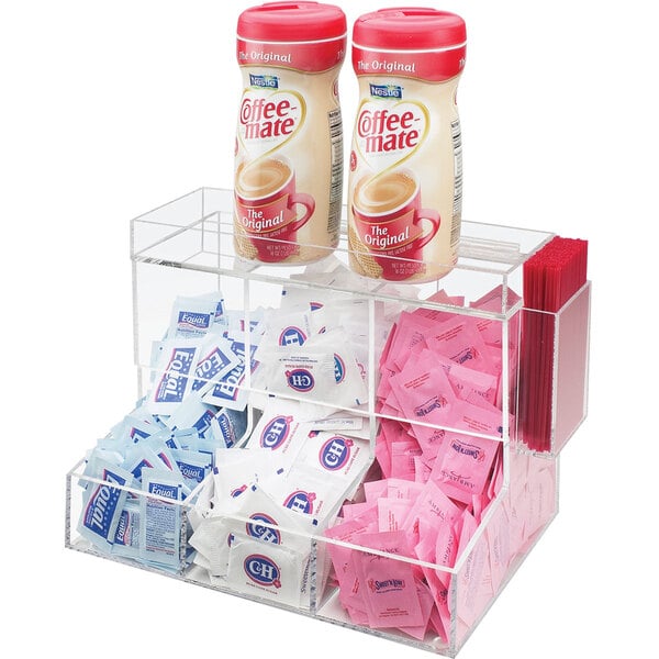 A clear Cal-Mil acrylic coffee condiment organizer on a counter with condiments inside.