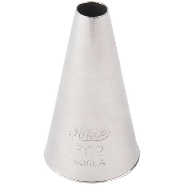 A silver cone shaped object with a black circle and the word "Korea" in white.