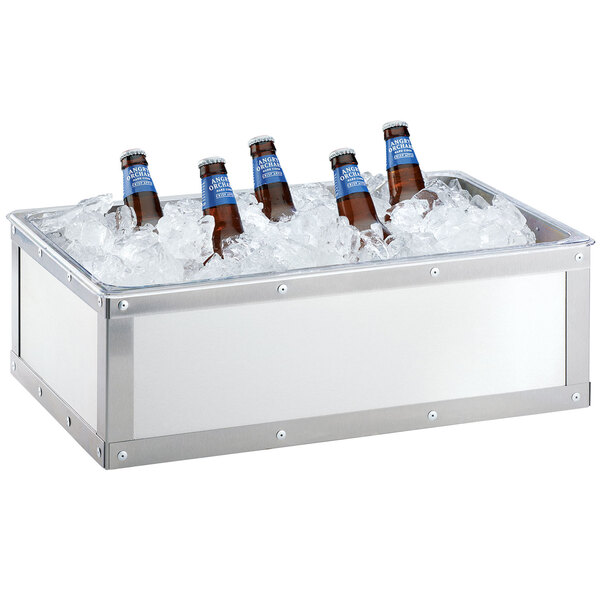 A Cal-Mil stainless steel ice housing holding bottles of beer on a table.