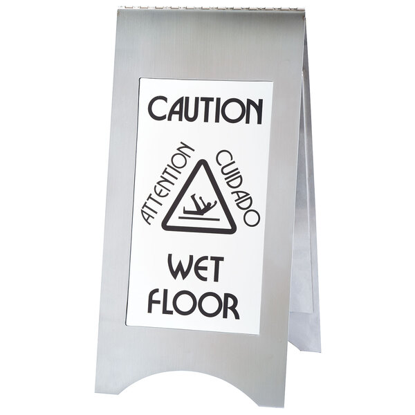 A white Cal-Mil stainless steel wet floor sign with caution signs on both sides.