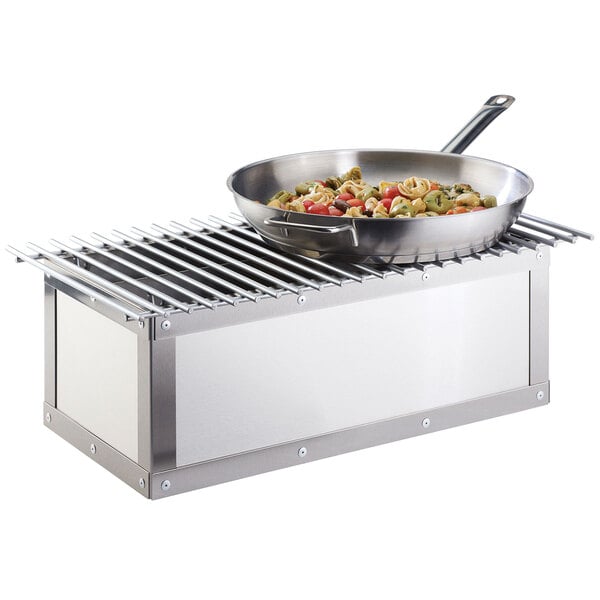 A Cal-Mil stainless steel chafer alternative pan with food in it on a table outdoors.