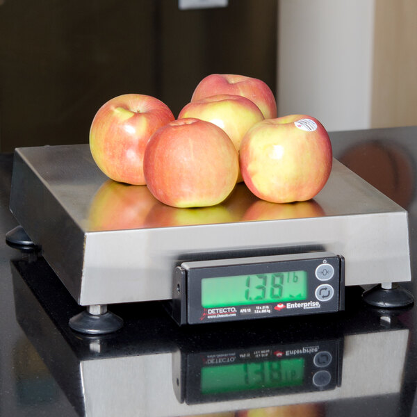 A Cardinal Detecto point of sale scale weighing a group of apples.