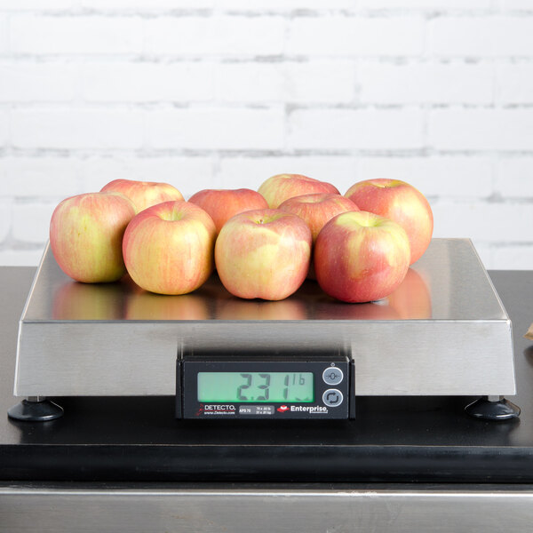 A Cardinal Detecto legal for trade scale with apples on it on a counter.