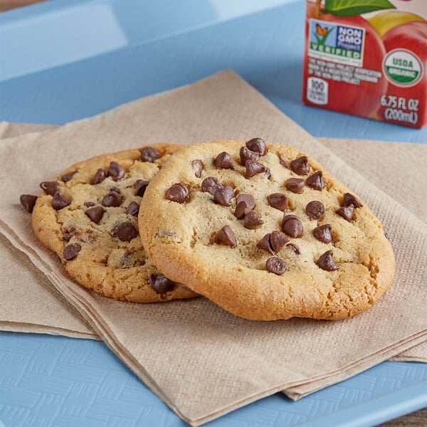 A chocolate chip cookie on a napkin.