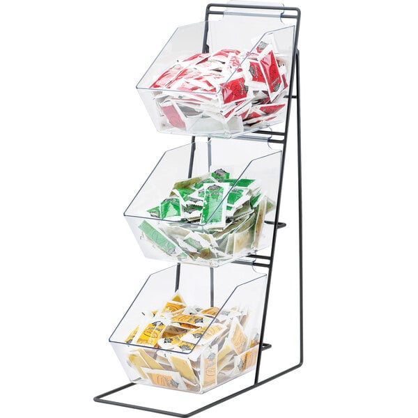 A black iron three tier Cal-Mil condiment display with clear bins full of various packets.