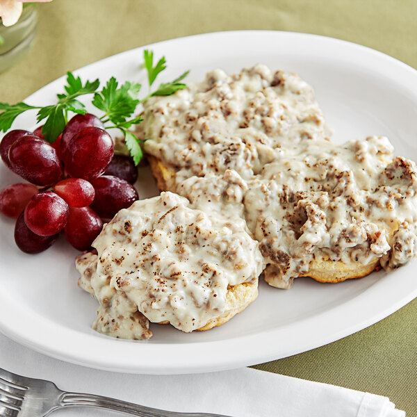 A plate of biscuits and Vanee peppered gravy with grapes.