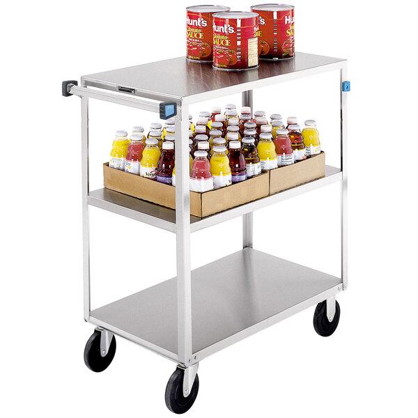 A Lakeside stainless steel utility cart with cans of juice and food on it.