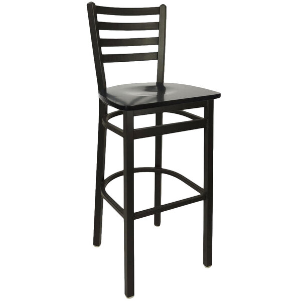 A BFM Seating black metal ladder back barstool with black wooden seat.