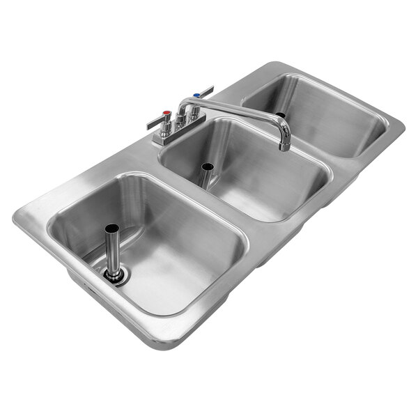 A stainless steel Advance Tabco drop-in bar sink with three compartments and faucets.