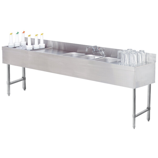 A stainless steel Advance Tabco underbar sink with two bowls and a left side ice bin.