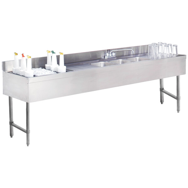 A stainless steel Advance Tabco underbar sink with three compartments and a left side ice bin.