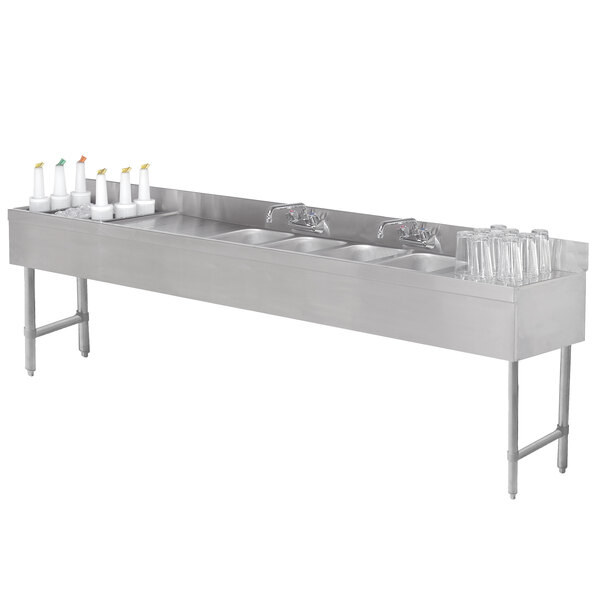 A stainless steel Advance Tabco underbar sink with four bowls, a faucet, and an ice bin on the left side.