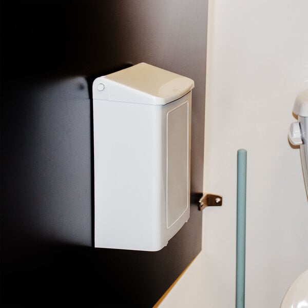 A white rectangular wall-mounted sanitary napkin receptacle with a black lid.