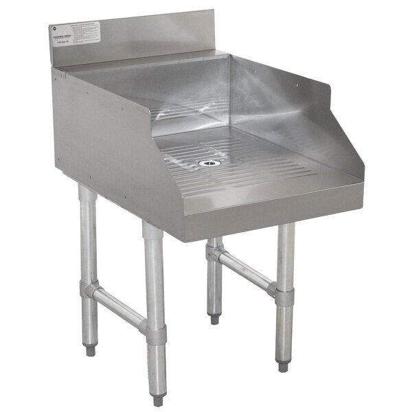An Advance Tabco stainless steel recessed bar drainboard installed in a counter.
