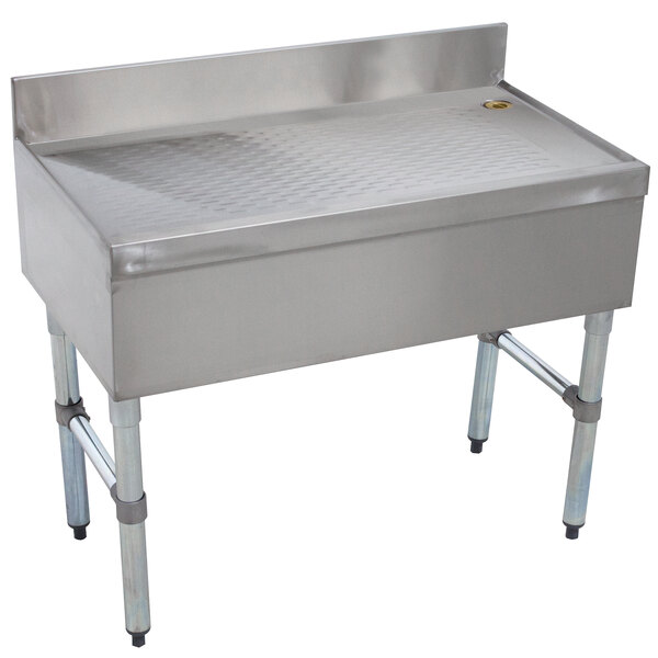 A stainless steel Advance Tabco free-standing bar drainboard with legs.