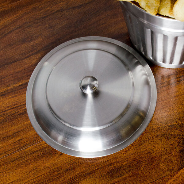 An American Metalcraft stainless steel mini trash can lid on a metal container.
