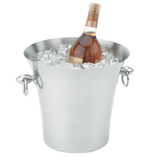 A Vollrath stainless steel fluted wine bucket filled with ice holding a wine bottle.