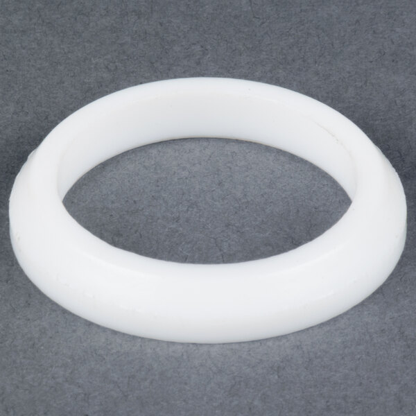 A white round object on a grey surface.